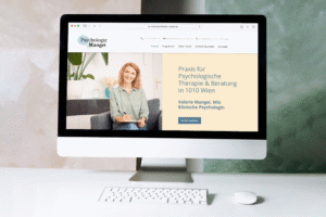Startseite der Website von Psychologie Mangei mit Portraitfoto, Claim und Buchungsbutton auf einem iMac Monitor